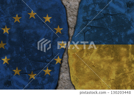 Symbolic split between European Union and Ukraine flags on cracked stone wall texture Symbolic split between European Union and Ukraine flags on cracked stone wall texture 130203448