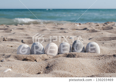 Handwritten word Greece on natural beach stone 130203469