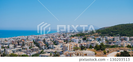 Panoramic view of the Greek city of Rethymno from a height on the island of Crete Greece. Residential buildings and the Aegean sea Panoramic view of the Greek city of Rethymno from a height on the island of Crete Greece. Residential buildings and the Aegean sea 130203513