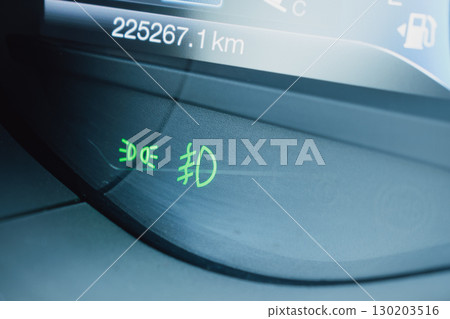Green fog light indicators on a car dashboard 130203516