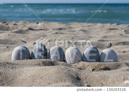 Travel Word Written on Stones at Tropical Beach 130203526
