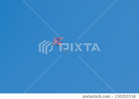 Kite against clear blue sky Kite against clear blue sky 130203536