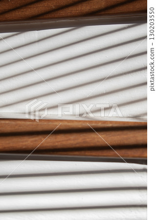 Sun-kissed wooden stairs with shadow play Sun-kissed wooden stairs with shadow play 130203550