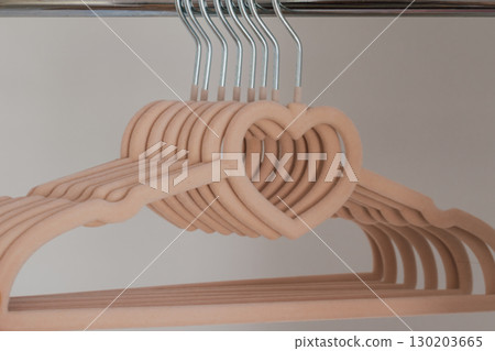 Children's beige velvet hangers with heart for girls clothes in empty wardrobe 130203665