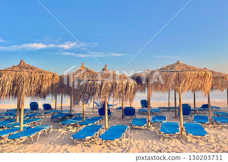 Chaotic sunbeds and palm-leaf umbrellas on Elafonissi beach, Crete, Greece Chaotic sunbeds and palm-leaf umbrellas on Elafonissi beach, Crete, Greece 130203731