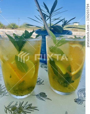 Refreshing Orange Mojito by the Pool 130203794
