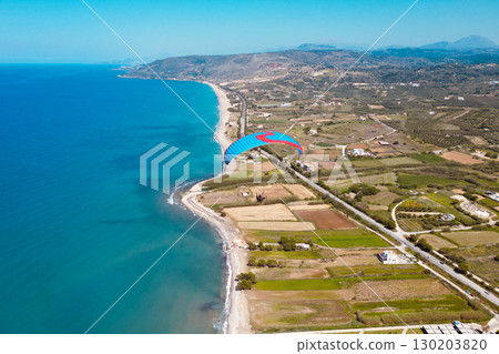 Paraglider Soaring Over the Longest Beach on Crete, Stretching from Georgioupoli to Rethymno 130203820