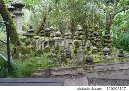 寧靜的日本寺廟景觀，青苔覆蓋的石塔和石佛像 130204137