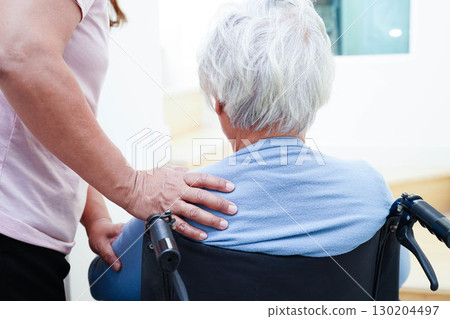 Caregiver help Asian elderly woman disability patient sitting on wheelchair in hospital. Caregiver help Asian elderly woman disability patient sitting on wheelchair in hospital. 130204497