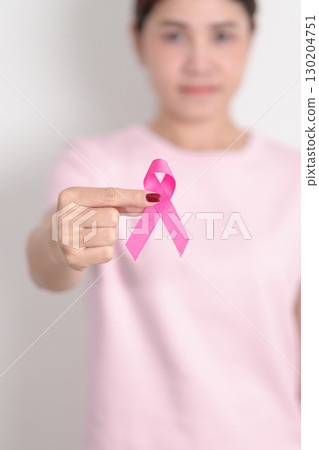 Pink October Breast Cancer Awareness month, woman with pink Ribbon for concepts of support people life and illness. National cancer survivors month, Women Health day and February World cancer day Pink October Breast Cancer Awareness month, woman with pink Ribbon for concepts of support people life and illness. National cancer survivors month, Women Health day and February World cancer day 130204751