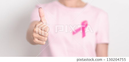 Pink October Breast Cancer Awareness month, woman with pink Ribbon for concepts of support people life and illness. National cancer survivors month, Women Health day and February World cancer day Pink October Breast Cancer Awareness month, woman with pink Ribbon for concepts of support people life and illness. National cancer survivors month, Women Health day and February World cancer day 130204755