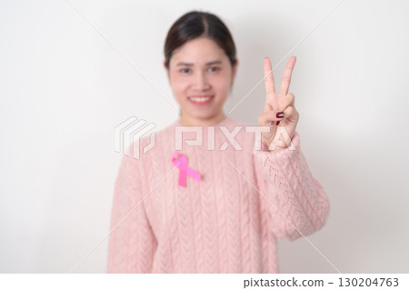 Pink October Breast Cancer Awareness month, woman with pink Ribbon for concepts of support people life and illness. National cancer survivors month, Women Health day and February World cancer day Pink October Breast Cancer Awareness month, woman with pink Ribbon for concepts of support people life and illness. National cancer survivors month, Women Health day and February World cancer day 130204763