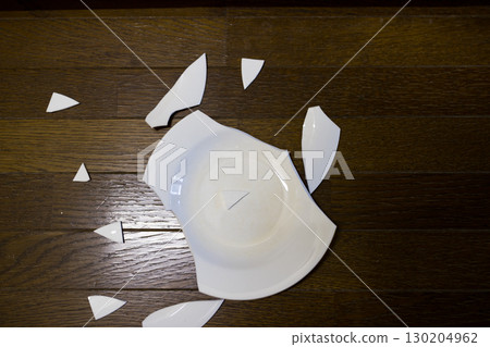 A plate that fell to the floor and broke 130204962