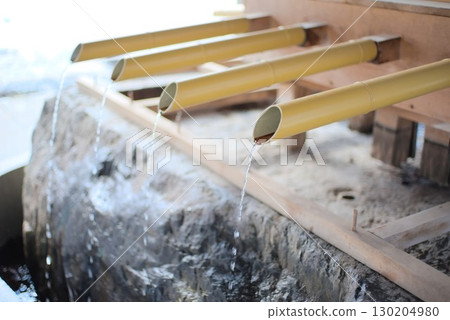Pure water dripping from a bamboo pipe and a traditional chozuya (purification fountain) Pure water dripping from a bamboo pipe and a traditional chozuya (purification fountain) 130204980