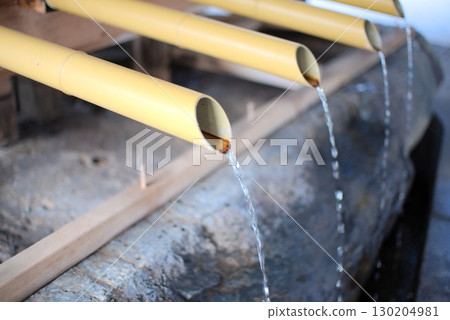 Pure water dripping from a bamboo pipe and a traditional chozuya (purification fountain) Pure water dripping from a bamboo pipe and a traditional chozuya (purification fountain) 130204981
