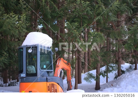 Snow-covered excavator and winter forest Snow-covered excavator and winter forest 130205016
