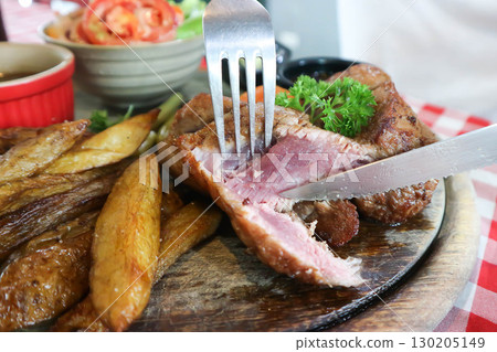 beef steak in gravy sauce or barbecued beef or grilled beef with French fries and vegetable salad 130205149