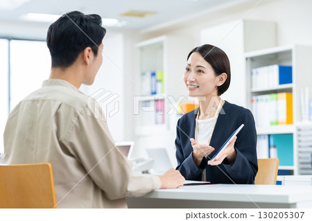 A businesswoman selling to a middle-aged man 130205307