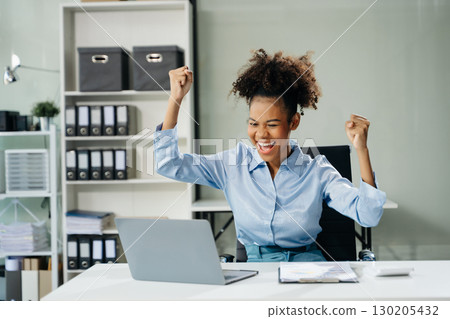 Business woman are delighted and happy with the work they do on their tablet, laptop and taking notes 130205432