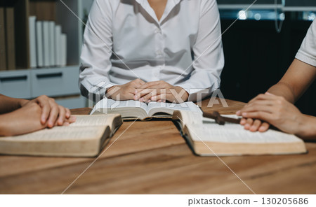 People reading and study bible in home and pray together.Studying the Word Of God People reading and study bible in home and pray together.Studying the Word Of God 130205686