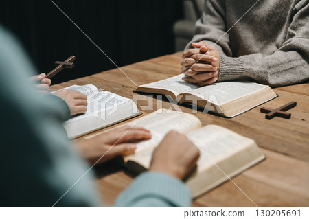 Christians are congregants join hands to pray and seek the blessings of God. Christians are congregants join hands to pray and seek the blessings of God. 130205691