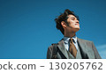 Businessman looking up at the blue sky | Suits, career, work style, business scene 130205762