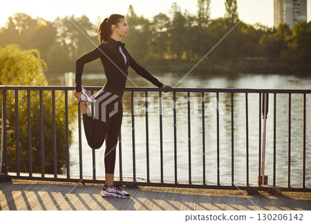 Sporty athletic woman doing warming up stretching exercises on outdoors. Sporty athletic woman doing warming up stretching exercises on outdoors. 130206142