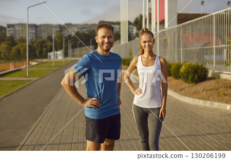 Full Length Portrait of a Smiling Sporty Couple in Urban Park 130206199