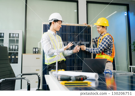 Alternative energy engineers discussing a project with a worker businesspeople a meeting in solar cell panel 130206751