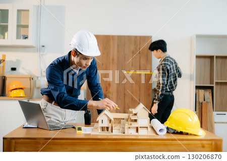 Architects and engineers collaborate on a building model, designing, planning, and measuring with teamwork, Architects and engineers collaborate on a building model, designing, planning, and measuring with teamwork, 130206870