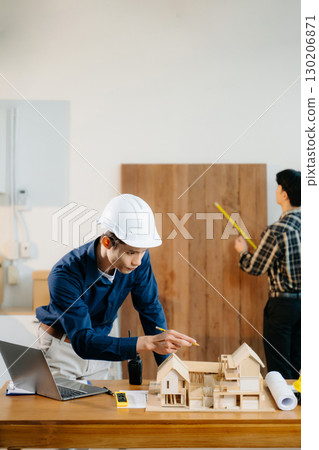 Engineer teams meeting working together wear worker helmets hardhat with on architectural project site Engineer teams meeting working together wear worker helmets hardhat with on architectural project site 130206871