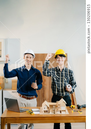 Architects and engineers collaborate on a building model, designing, planning, and measuring with teamwork, Architects and engineers collaborate on a building model, designing, planning, and measuring with teamwork, 130206915