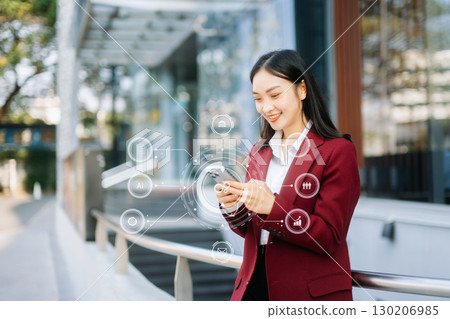 Digital marketing media in virtual screen.businesswoman hand working with mobile phone and modern compute 130206985