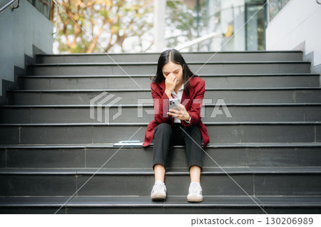 Young Asian business woman leader entrepreneur, professional manager holding digital tablet computer in big city Young Asian business woman leader entrepreneur, professional manager holding digital tablet computer in big city 130206989