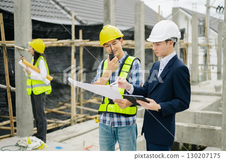 Contractor and architect looking at plan, tablet, laptop and talking about working on big project. Contractor and architect looking at plan, tablet, laptop and talking about working on big project. 130207175