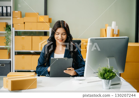 Startup small business SME, Entrepreneur owner woman using smartphone or tablet taking receive and checking Startup small business SME, Entrepreneur owner woman using smartphone or tablet taking receive and checking 130207244