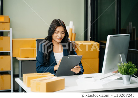 Startup small business SME, Entrepreneur owner woman using smartphone or tablet taking receive and checking Startup small business SME, Entrepreneur owner woman using smartphone or tablet taking receive and checking 130207245