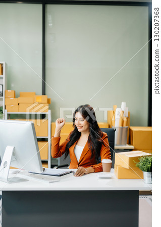 Woman Entrepreneur: SME Business mastering e-commerce with tablet, laptop, packaging, Woman Entrepreneur: SME Business mastering e-commerce with tablet, laptop, packaging, 130207368