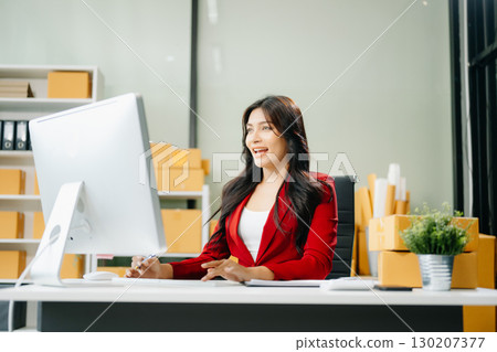 Woman Entrepreneur: SME Business mastering e-commerce with tablet, laptop, packaging, Woman Entrepreneur: SME Business mastering e-commerce with tablet, laptop, packaging, 130207377