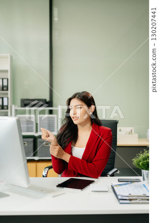 Overworked young Asian businesswoman office worker suffering from neck pain after had a long day Overworked young Asian businesswoman office worker suffering from neck pain after had a long day 130207441