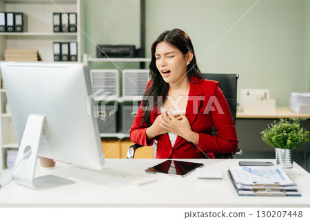 Overworked young Asian businesswoman office worker suffering from neck pain after had a long day Overworked young Asian businesswoman office worker suffering from neck pain after had a long day 130207448