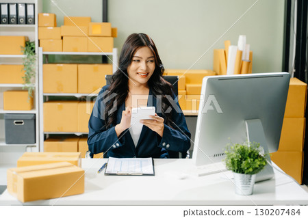Startup small business SME, Entrepreneur owner woman using smartphone or tablet taking receive and checking 130207484