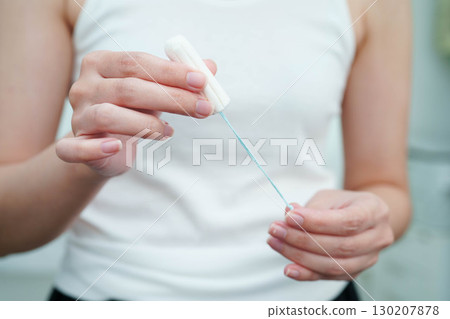 Asian woman holding cotton tampons for hygiene menstrual period cycle protection. Asian woman holding cotton tampons for hygiene menstrual period cycle protection. 130207878