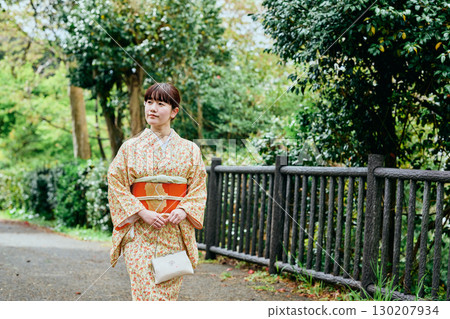A young woman strolling around in a kimono A young woman strolling around in a kimono 130207934