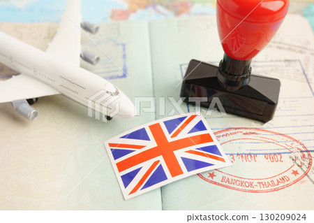 UK United Kingdom passport with approved stamp on document for tourism to immigration at airport in country. UK United Kingdom passport with approved stamp on document for tourism to immigration at airport in country. 130209024