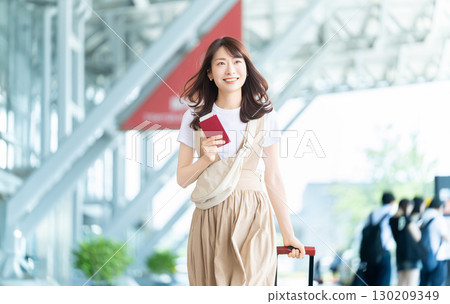 Traveling woman with passport at airport Traveling woman with passport at airport 130209349