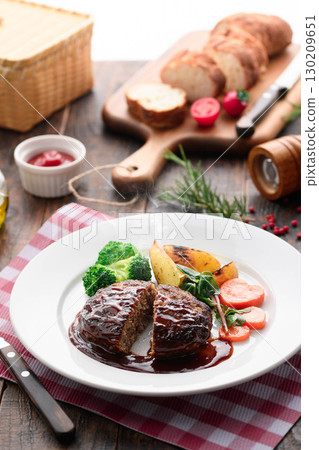 Hamburger steak with demi-glace sauce and colorful vegetables - a homey and warm Western-style meal 130209651