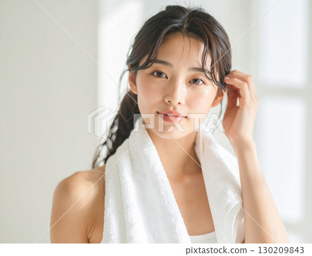 Young woman with a towel around her neck 130209843