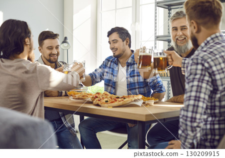 Smiling bearded male friends with beer and pizza having fun sitting at home. Smiling bearded male friends with beer and pizza having fun sitting at home. 130209915