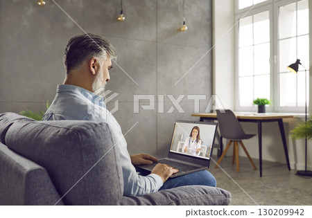 Mature man getting medical consultation from online doctor via video call on laptop Mature man getting medical consultation from online doctor via video call on laptop 130209942